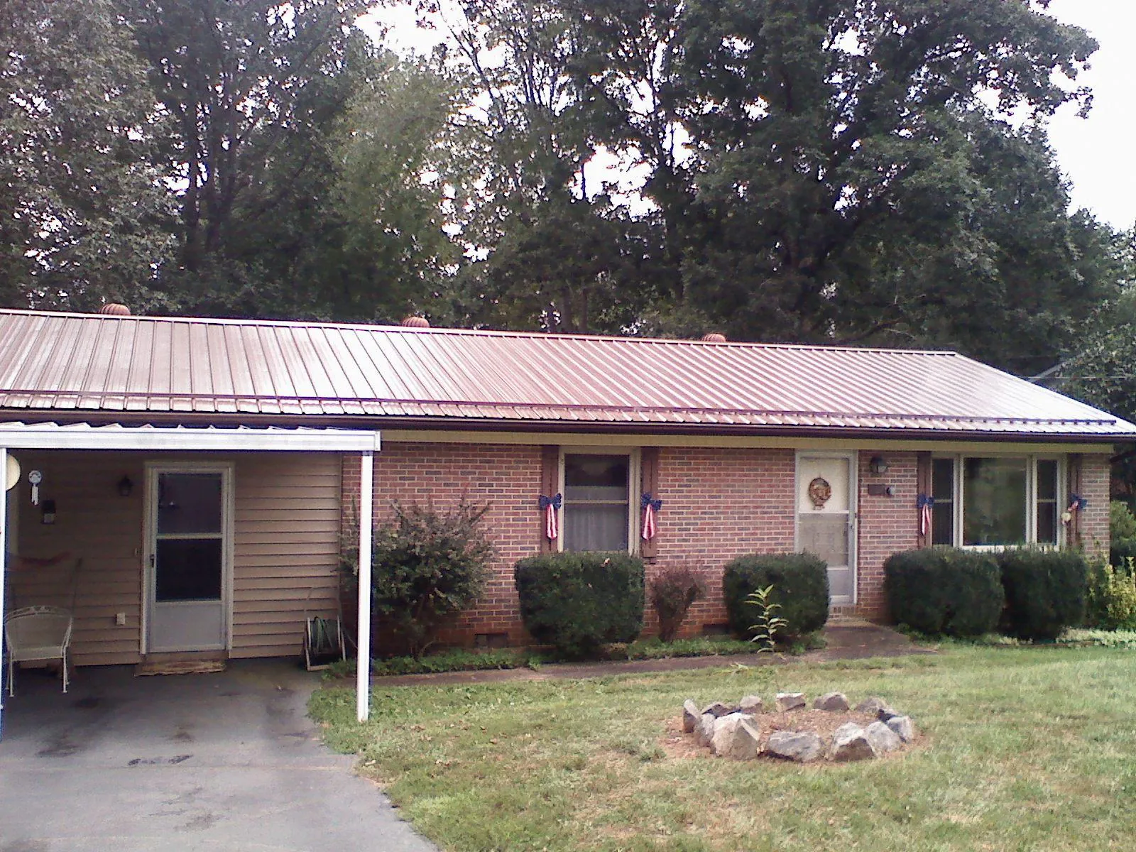 Bronze metal roof and carport on a brick ranch home — Roof Repair work by our crew in Alamo
